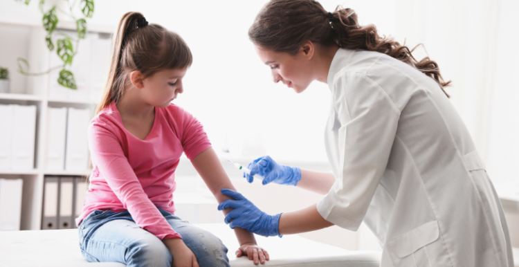 A nurse vaccinating a young girl.