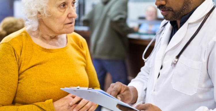 An elderly woman talking to a doctor