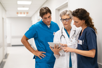 Nurses and doctors discussing a report