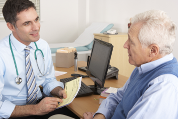 A picture of a doctor talking with a patient during an appointment.