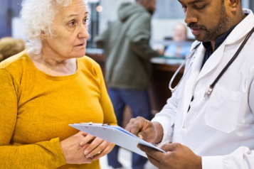 An elderly woman talking to a doctor