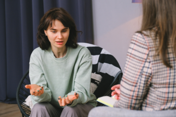 A woman talking to a psychiatrist. 