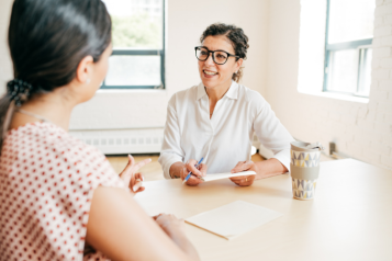 A healthcare professional offering lifestyle advice to a young person.